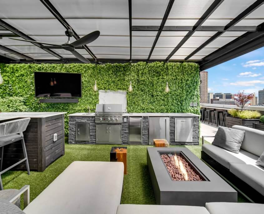 Covered outdoor kitchen with firepit, TV, and lounge