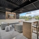 covered rooftop tv lounge with custom metal privacy screens